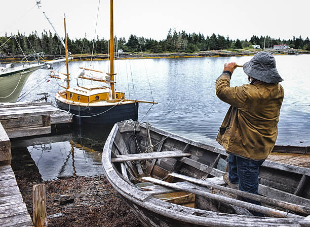 istock Fisherman Standing in a Dory with Telescope, Nova Scotia. 467003746