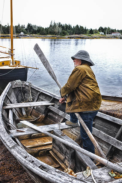 istock Fisherman Standing in a Dory, Mahone Bay, Nova Scotia 467003748