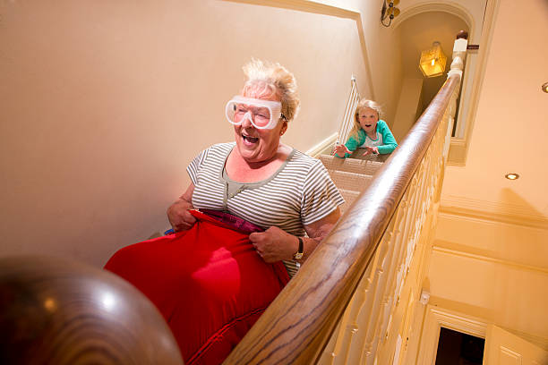 great daredevil daredevil gran comes down the stairs in a sleeping bag toboggan exhilaration photos stock pictures, royalty-free photos & images