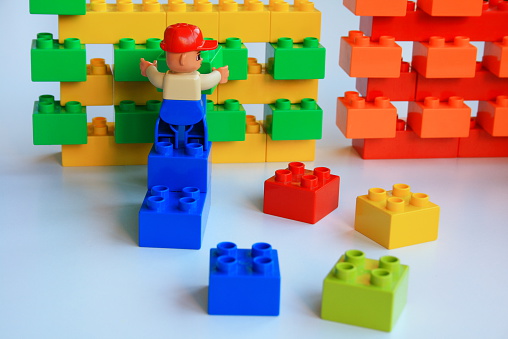 Alcobendas, Spain - August 6, 2014: Lego-Duplo minifigure is ordering blocks. Lego is manufactured by the Lego Group