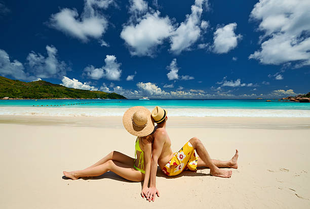 istock Couple sitting on a beach at Seychelles 467005426