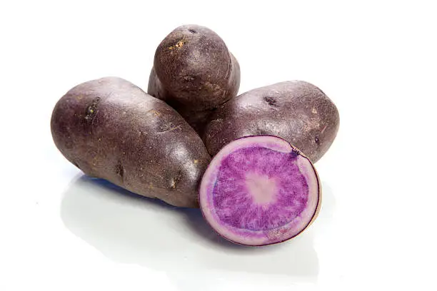 purple potatoes on white background