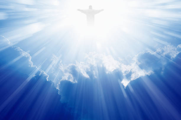 Jesus Christ in heaven Jesus Christ in blue sky with clouds, bright light from heaven, resurrection, easter easter sunday stock pictures, royalty-free photos & images