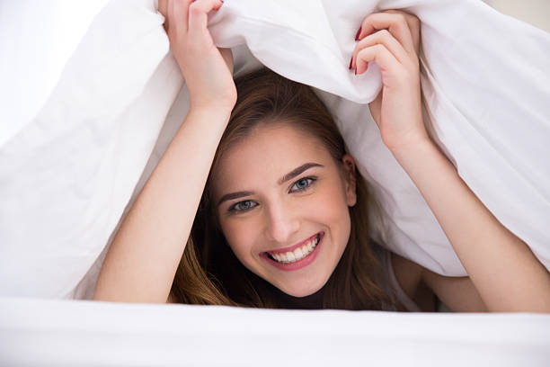 istock woman under the blanket in the bed 467005990