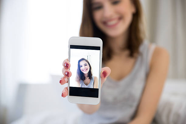 istock woman making selfie photo on smartphone 467006014