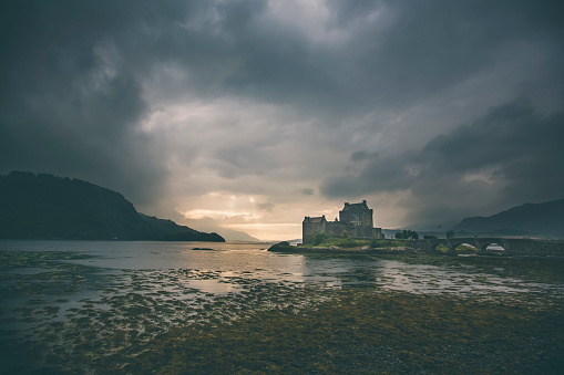 Dornie, Unted Kingdom - September 4, 2014: Dramatic sunset in Loch Duich with Eilean Donan castle.