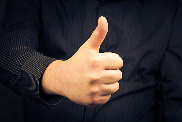 istock Closeup man hand showing thumb 467006395