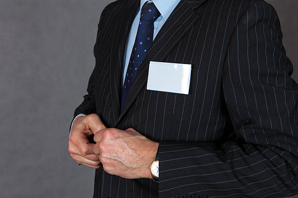 istock Businessman holding blank ID badge 467010714