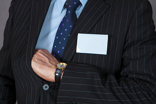 istock Businessman holding blank ID badge 467010812