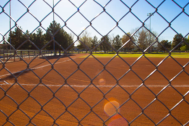 istock Baseball Field Through Fence with Trees in Background 467010998