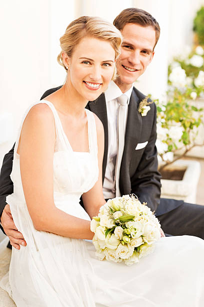 istock Groom Sitting With Arm Around Bride 467014155