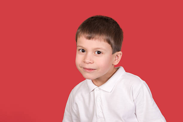istock boy portrait in white shirt on red 467016511