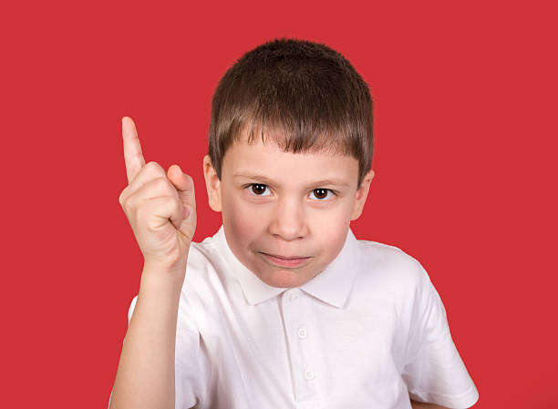 istock boy portrait in white shirt on red 467016551