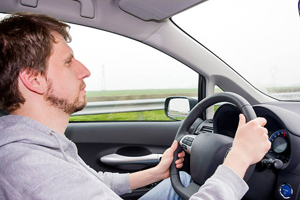 istock man driving a car in the rain 467020813