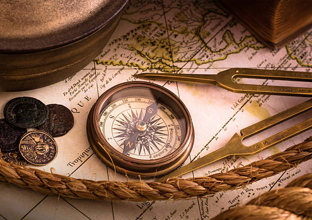 Vintage compass with map and tools Vintage compass lies on an medieval map nautical compass stock pictures, royalty-free photos & images