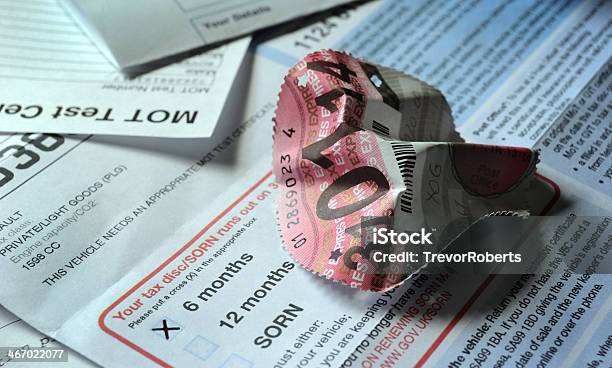 Crumpled British Car Road Tax Disc With Documents Stock Photo - Download Image Now - Tax, Car, Road