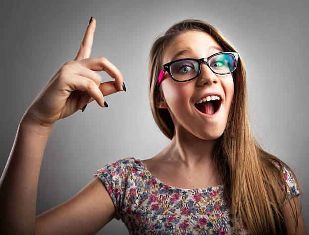 istock Girl with glasses pointing up 467029613