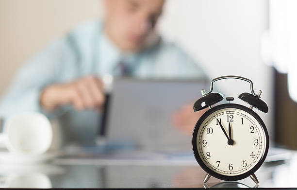 istock Black alarm clock on a businessman's desk 467029913