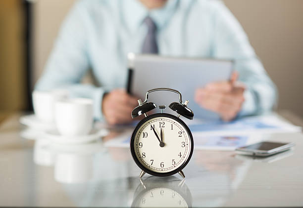 istock Close-up alarm clock showing time in business office 467030103