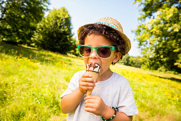 little boy lamer helado en un cono de - ice cream licking little boys ice cream cone fotografías e imágenes de stock