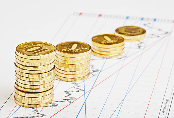istock Downtrend coins stacks on financial chart. Selective focus 467030589