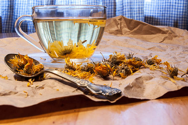 istock Glass cup of herbal tea, teespoon on wrapping paper. 467030909