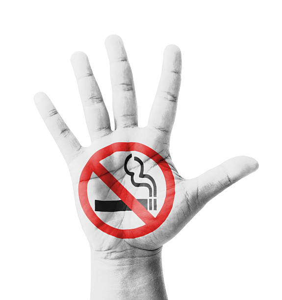 Open hand raised, No Smoking sign painted stock photo