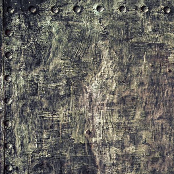 istock Grunge black metal plate with rivets screws background texture 467037877