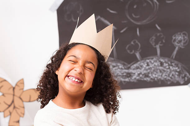 istock Child girl with paper crown 467041016