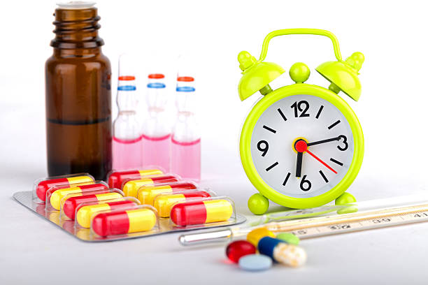 istock Close up shot of various medicines and bottles with a clock 467041252