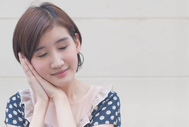istock beautiful young woman taking a nap 467042051