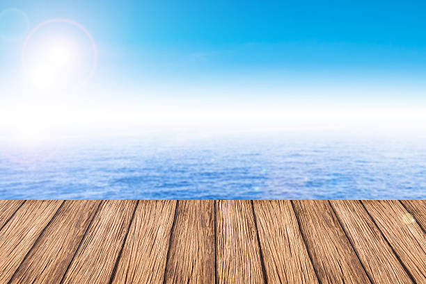 istock Empty wooden deck table with copy space and sea background. 467044288
