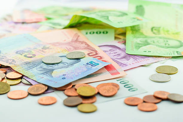 istock Thai money banknotes and coins 467047550