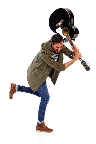 Image of frustrated young man about to break his guitar over white background