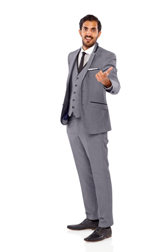 Full length image of happy young businessman pointing at you against white background