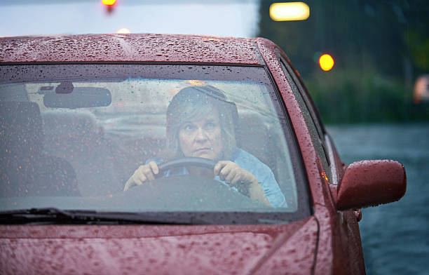 Shot of a mature woman driving in the rainhttp://195.154.178.81/DATA/istock_collage/1225823/shoots/785177.jpg