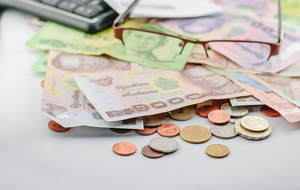 istock Thai money banknotes and coins 467052610