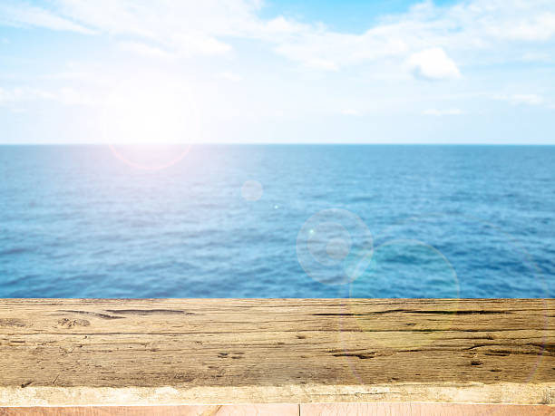 istock Empty wooden deck table with copy space and sea background. 467053262