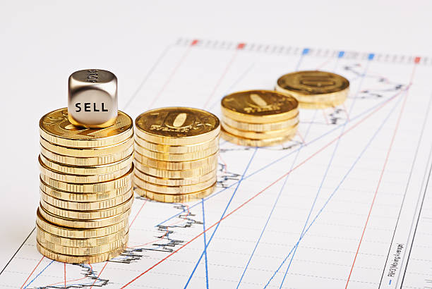 istock Coins stacks downtrend and  dices cube with the word SELL 467054683