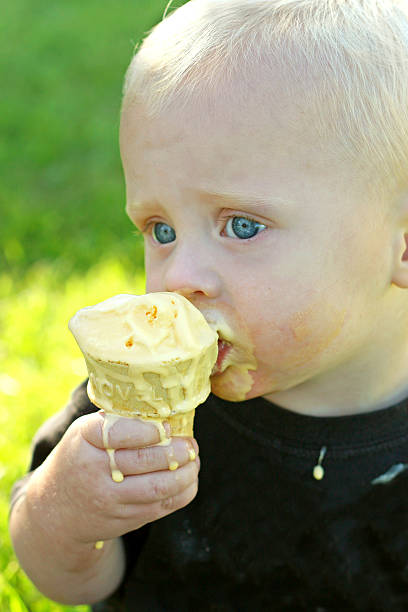 istock Messy Baby Eating Ice Cream Cone 467060821