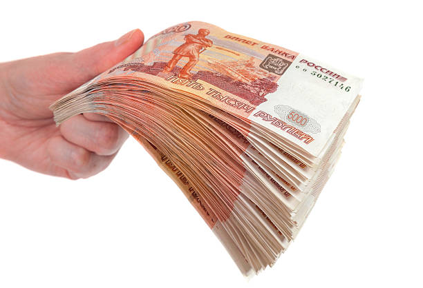 istock Hand with russian roubles bills isolated on white background 467061835