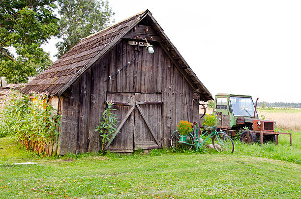 istock old farm wooden building and broken tractor 467063773