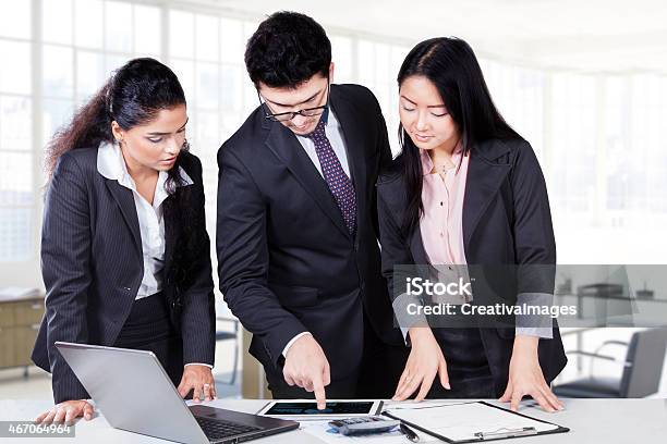 Male Manager Pointing Chart On Tablet Stock Photo - Download Image Now - Adult, Asian and Indian Ethnicities, Business