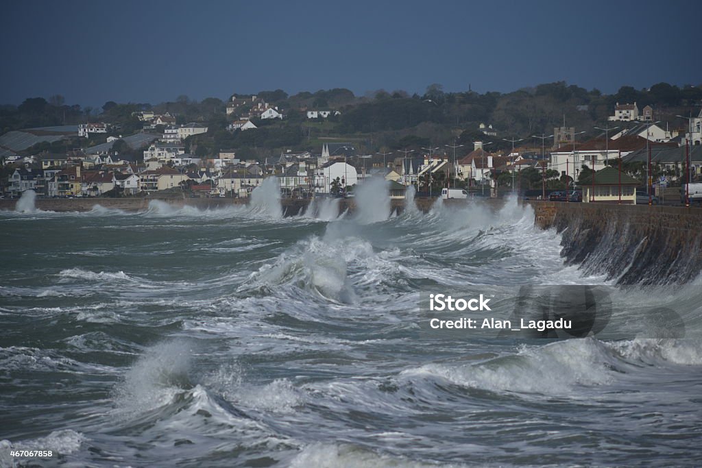 West Park, Jersey, U.K. Telephoto image of Winter seas pounding the promenade. Storm Stock Photo