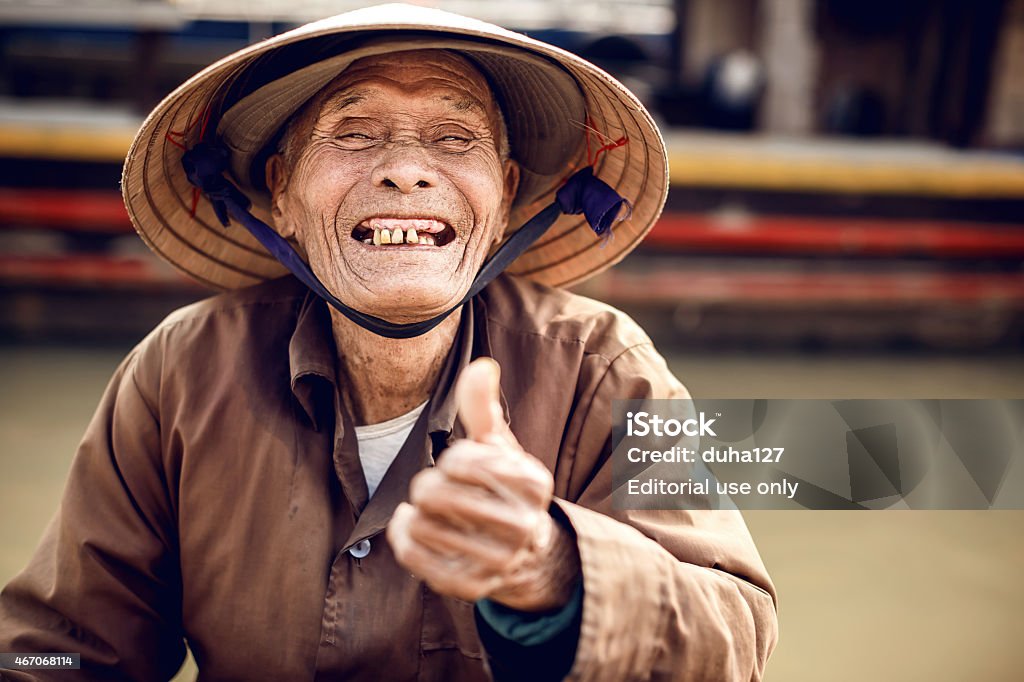 Old man in a boat in river Hue, Vietnam - December 26, 2013: Old man in a boat at Song Hurong river a.k.a. The Perfume River  Asia Stock Photo