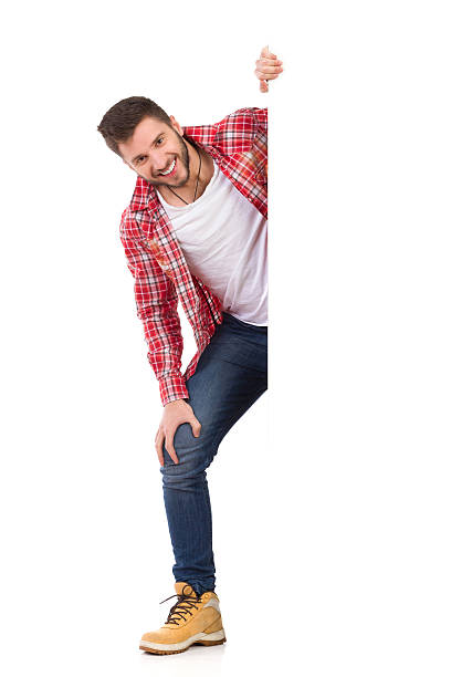 istock Smiling man peeking behind white banner 467068434