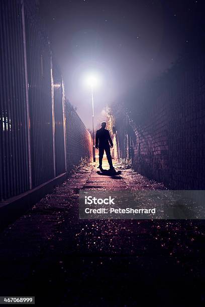 The Silhouette Of Man Standing In Dark Alley Stock Photo - Download Image Now - Running, Men, Night