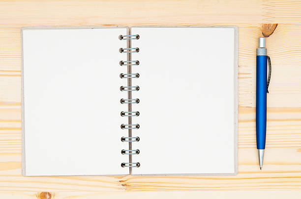 istock Paper spiral notebook and pen closeup 467069294