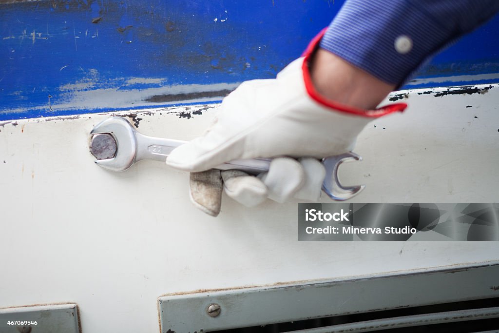 Worker using a wrench 2015 Stock Photo