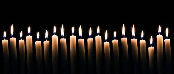 lots of candles on a dark background